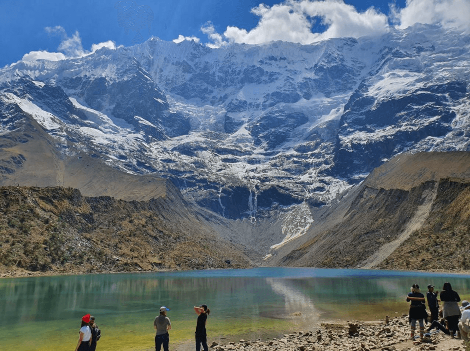 The Humantay Lake and tourists taking photos.